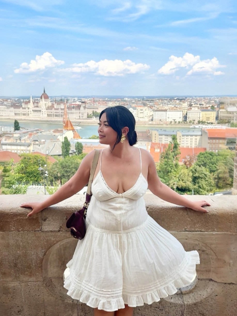 Jhayde Charlaine McCabe overlooking a European city in a white dress