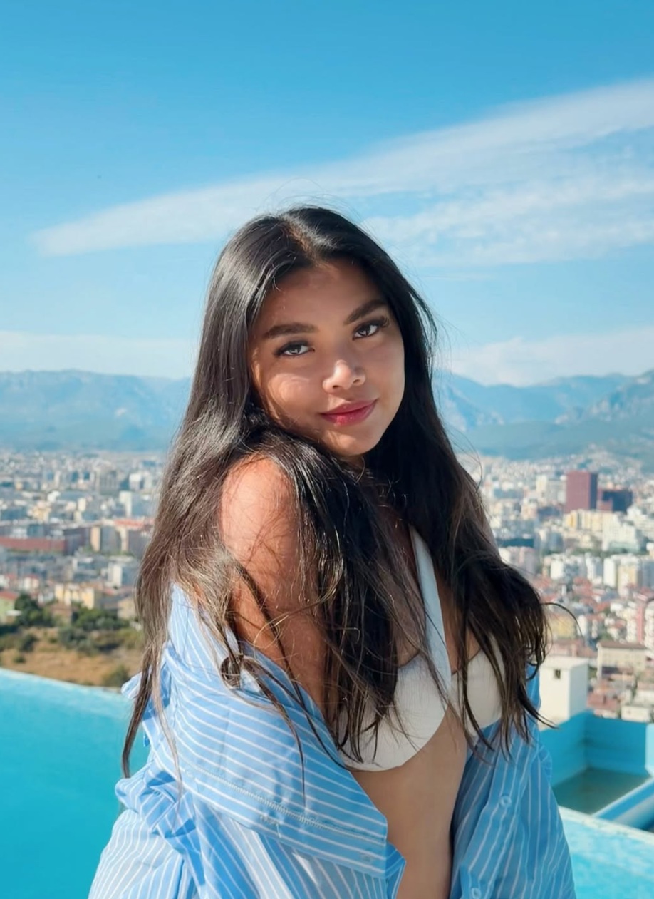 Jhayde Charlaine McCabe smiling against a mountain city view